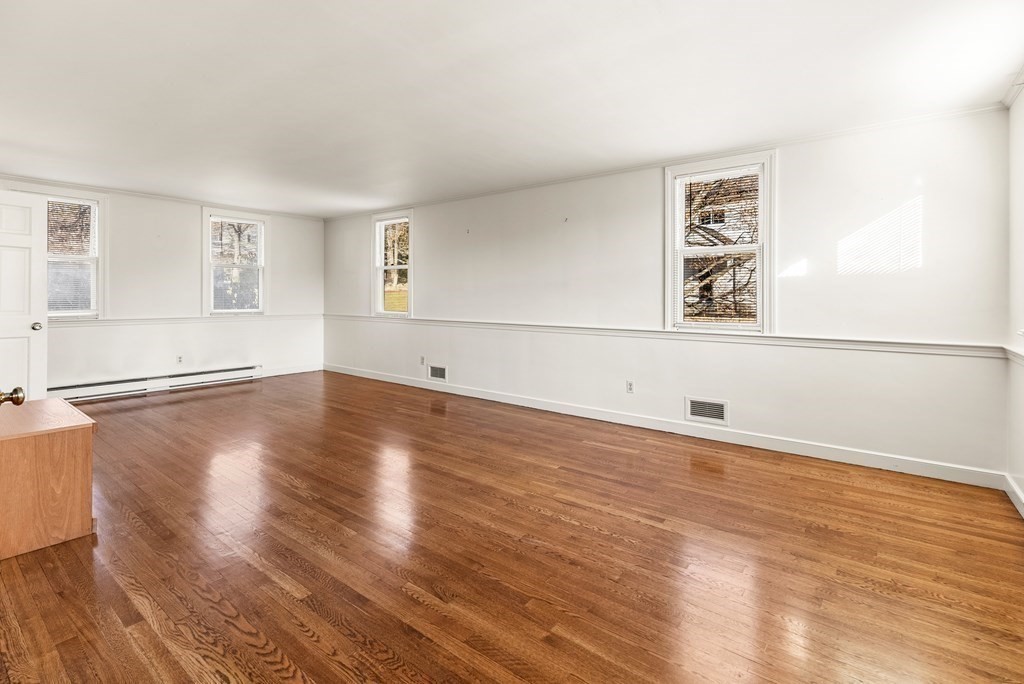 1140 Webster Street Needham, MA 02492 - Photo 3 of 27 an empty room with wooden floor and windows
