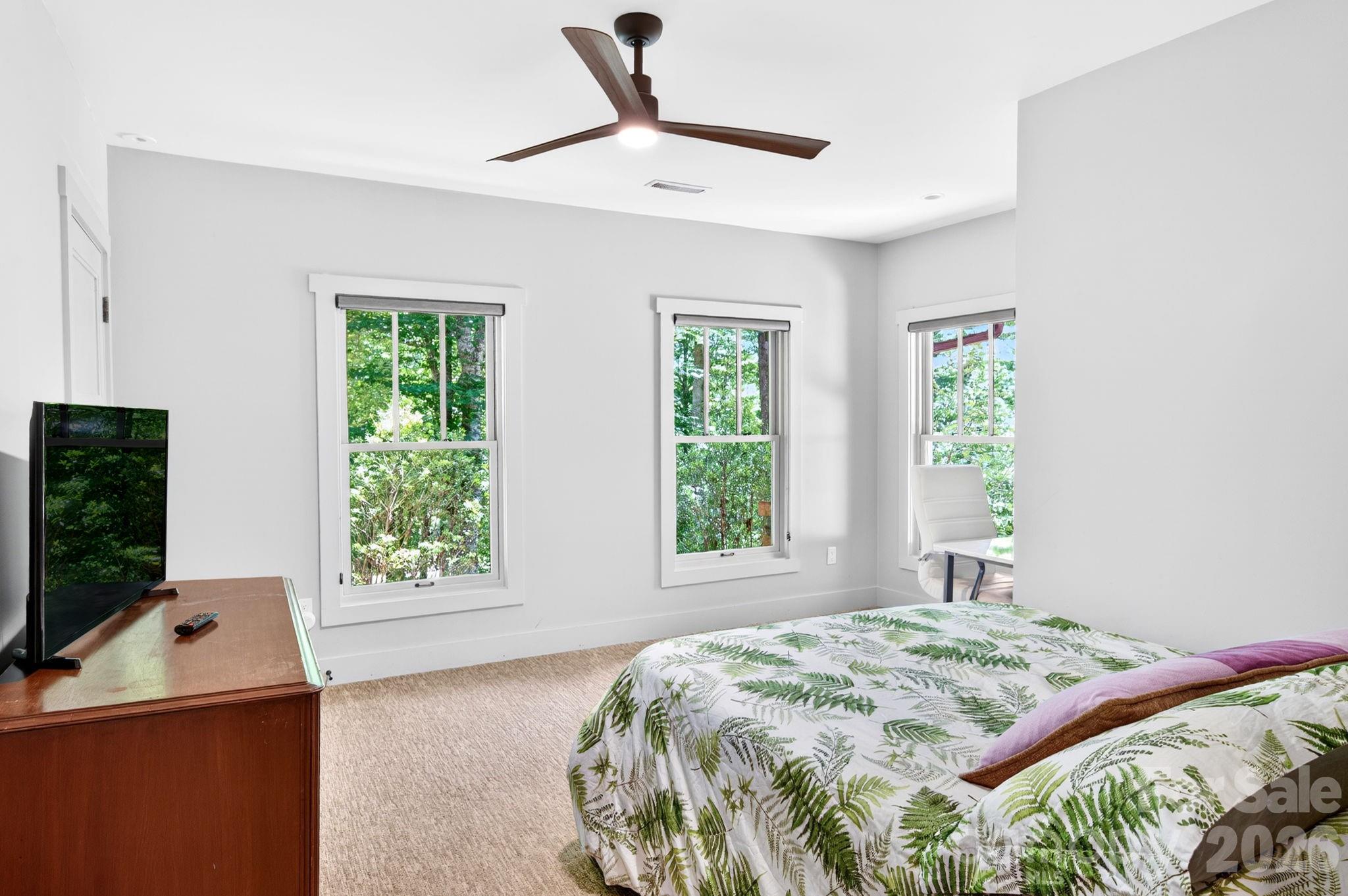 235 Bull Creek Road Asheville, NC 28805 - Photo 30 of 47 a bedroom with a bed and large window