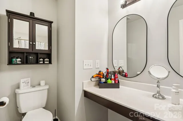 a bathroom with a toilet a sink and a mirror
