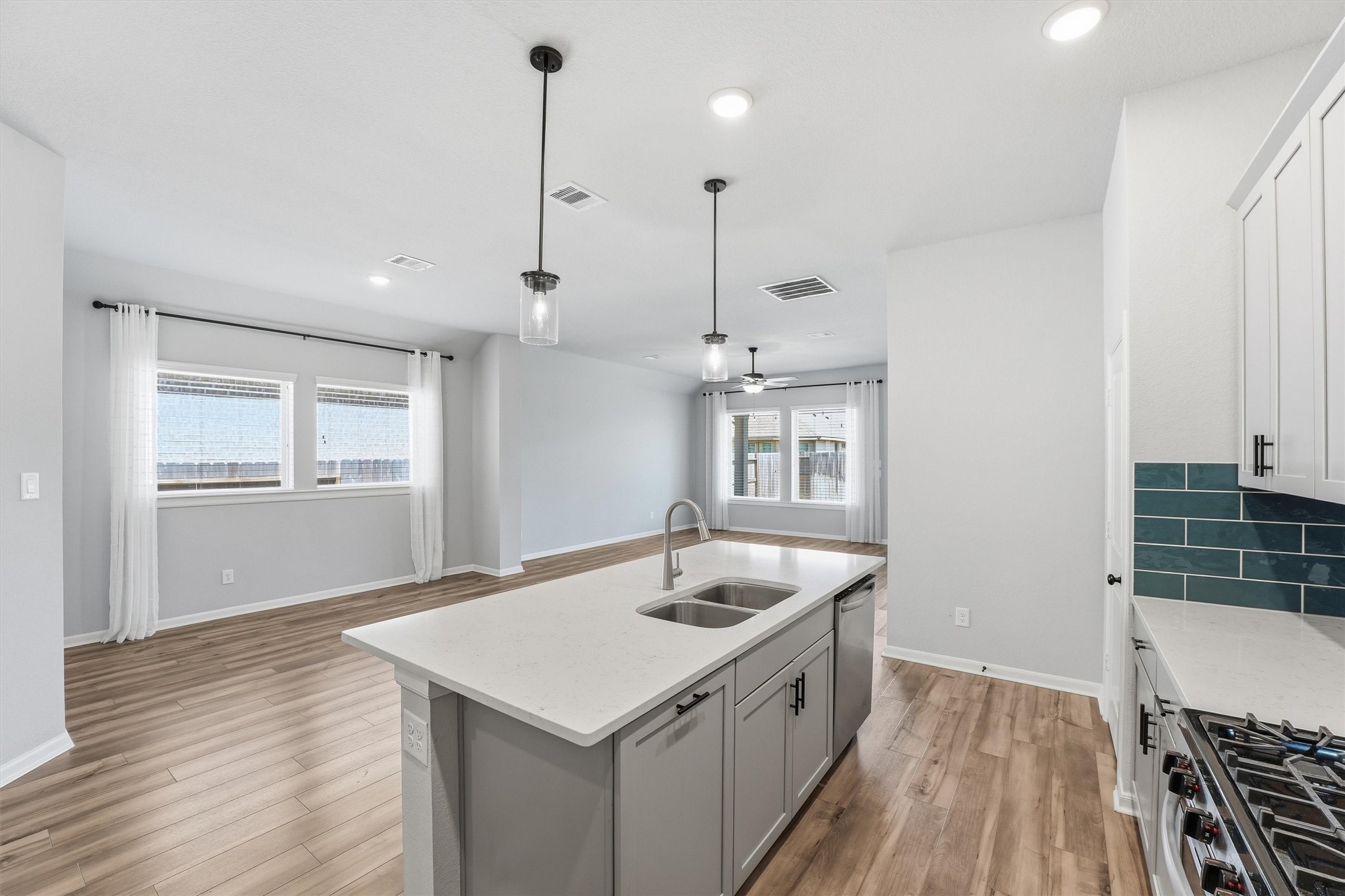 1338 Lakeside Crk Road Magnolia, TX 77354 - Photo 12 of 37 a kitchen with a sink a counter space wooden floor and a window