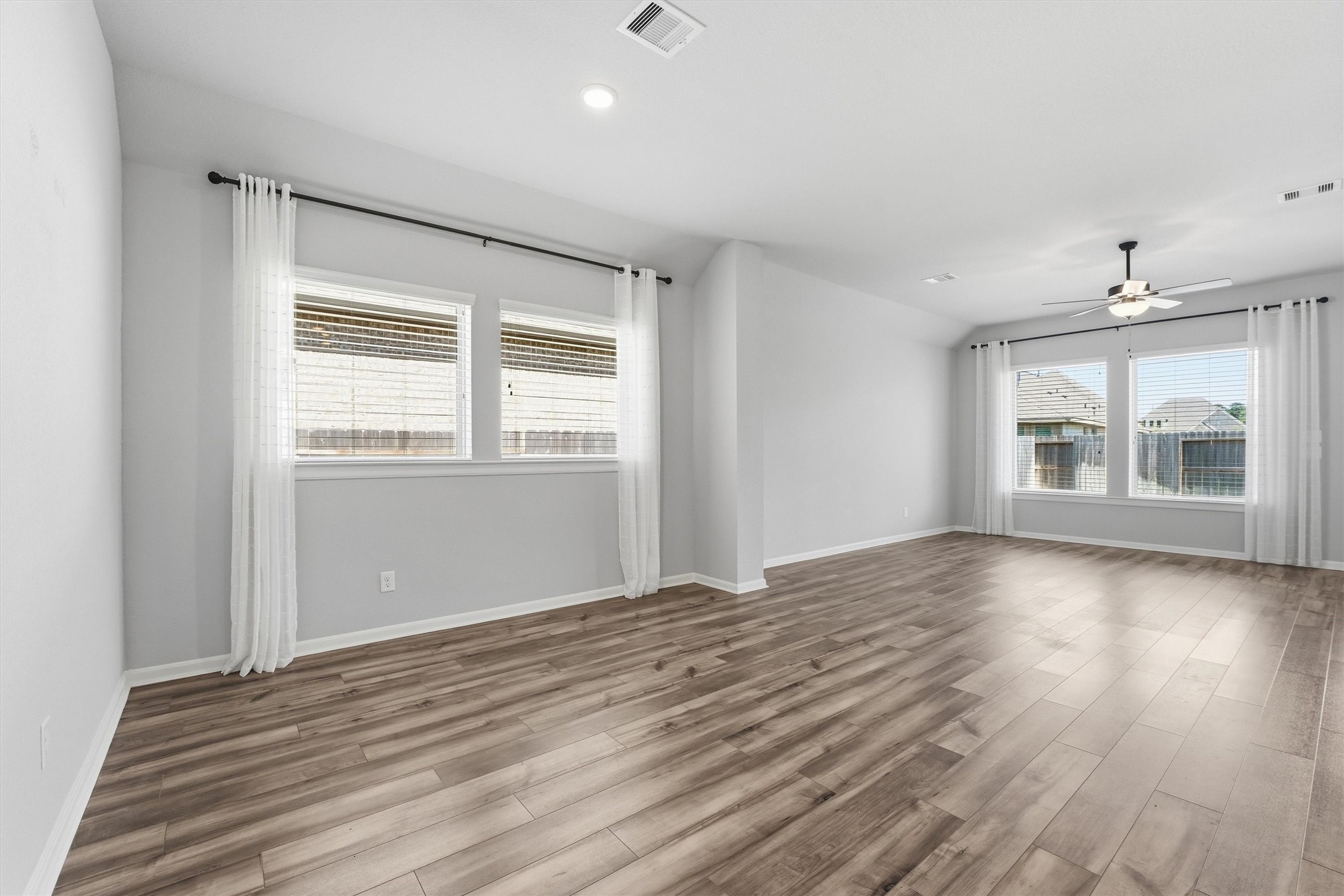1338 Lakeside Crk Road Magnolia, TX 77354 - Photo 14 of 37 an empty room with wooden floor and windows