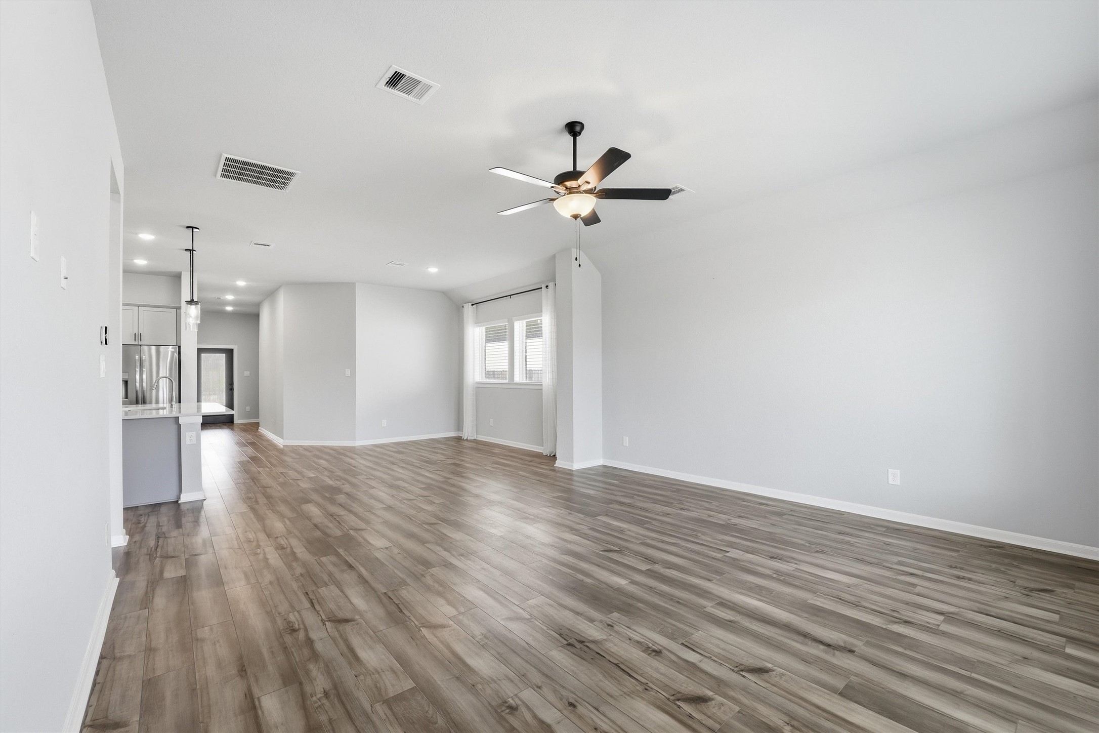1338 Lakeside Crk Road Magnolia, TX 77354 - Photo 17 of 37 a view of a room with wooden floor and a ceiling fan