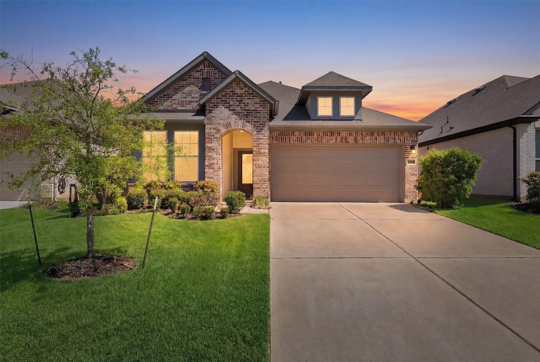 1338 Lakeside Crk Road Magnolia, TX 77354 - Photo 2 of 37 a front view of a house with a garden and yard