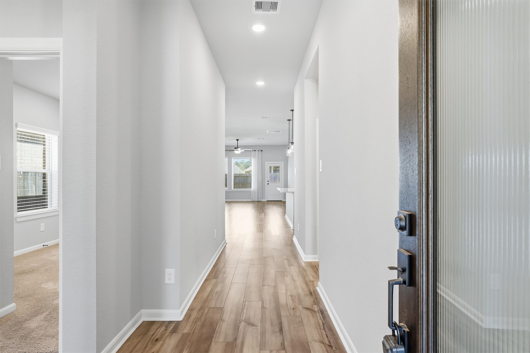 1338 Lakeside Crk Road Magnolia, TX 77354 - Photo 5 of 37 a view of a hallway with wooden floor and staircase
