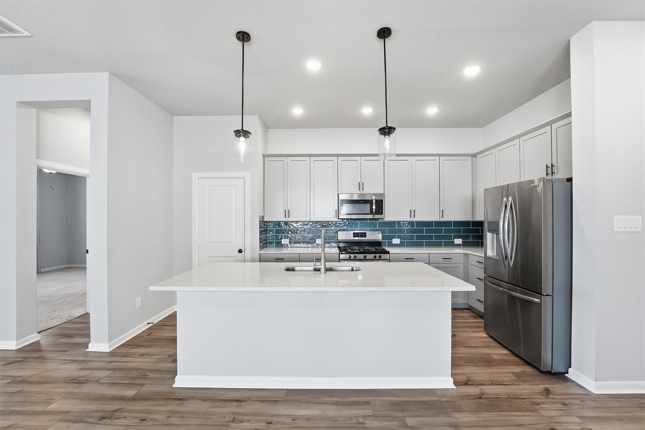 1338 Lakeside Crk Road Magnolia, TX 77354 - Photo 10 of 37 a view of a kitchen with stainless steel appliances granite countertop a refrigerator a sink dishwasher a oven and a wooden floor