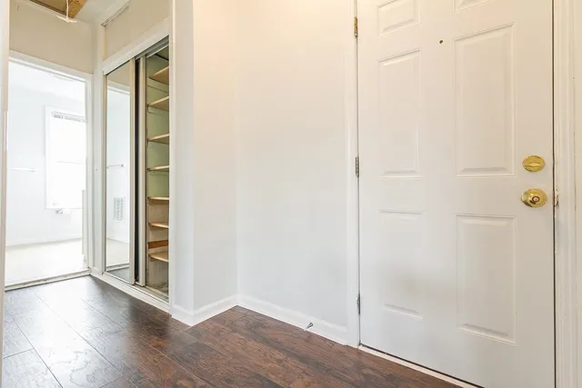 a view of a hallway with wooden floor