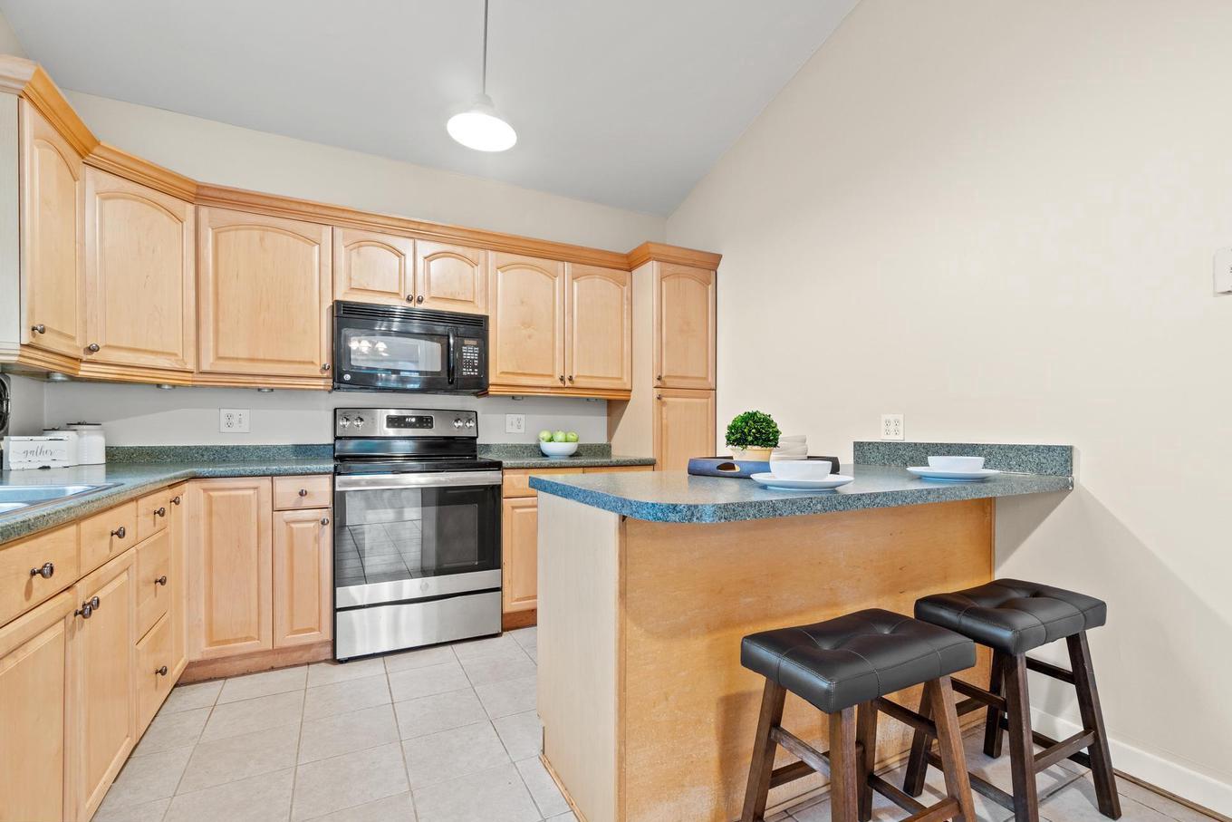 6505 Farley Street Springfield, VA 22152 - Photo 8 of 30 a kitchen with stainless steel appliances granite countertop a stove a sink dishwasher and a refrigerator