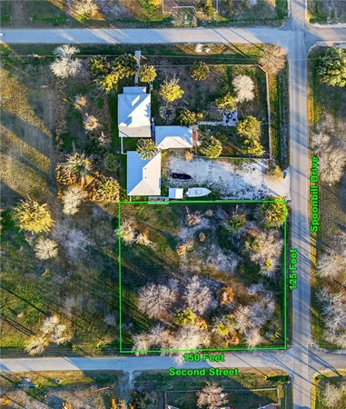 an aerial view of a house with a yard basket ball court and outdoor seating