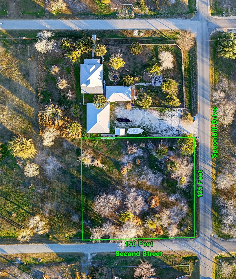 402 2nd Street Bayside, TX 78340 - Photo 6 of 9 an aerial view of a house with a yard basket ball court and outdoor seating