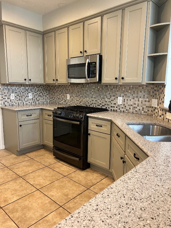 25402 China Springs Spring, TX 77373 - Photo 6 of 11 a kitchen with stainless steel appliances kitchen island granite countertop a sink stove and cabinets