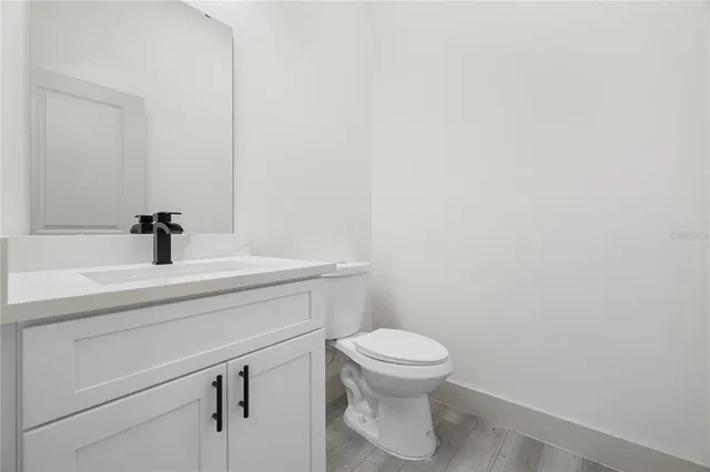 a bathroom with a sink a toilet and a mirror