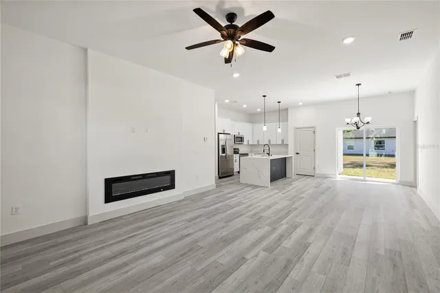 a view of a kitchen with a sink and a stove top oven