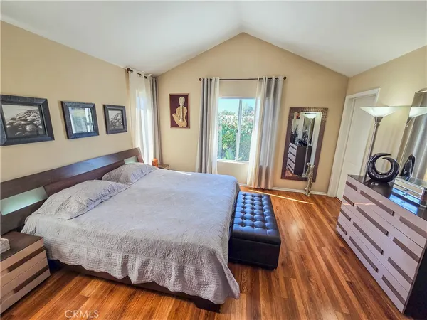 a bedroom with a bed and a large mirror
