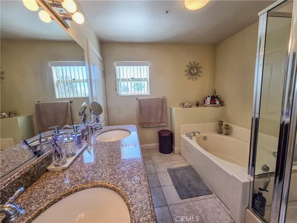 a bathroom with a sink a mirror and a shower
