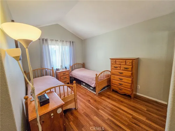a bedroom with furniture and wooden floor