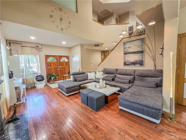 a living room with furniture and wooden floor