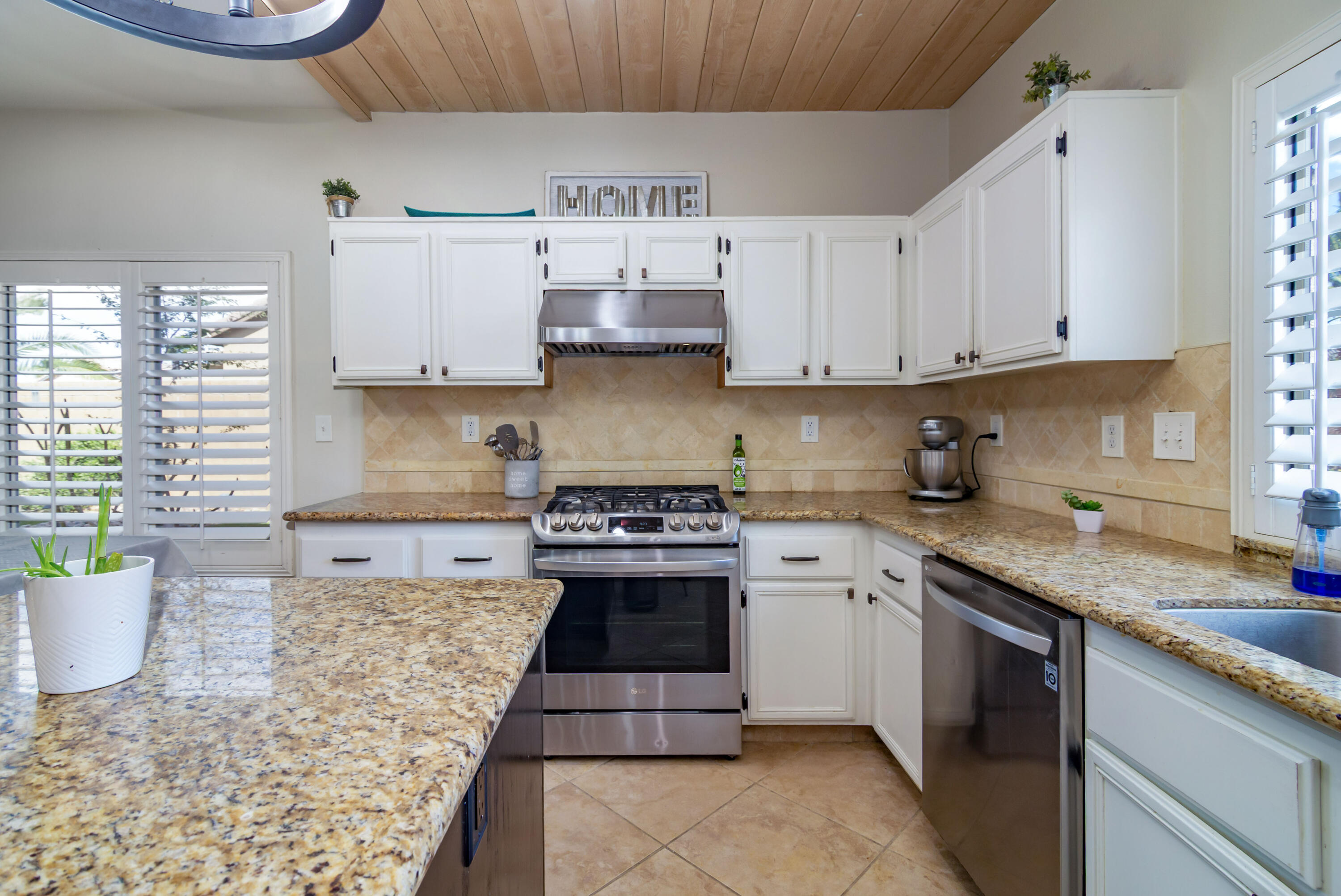 40681 Morris Street Indio, CA 92203 - Photo 16 of 36 a kitchen with stainless steel appliances granite countertop a stove sink and cabinets