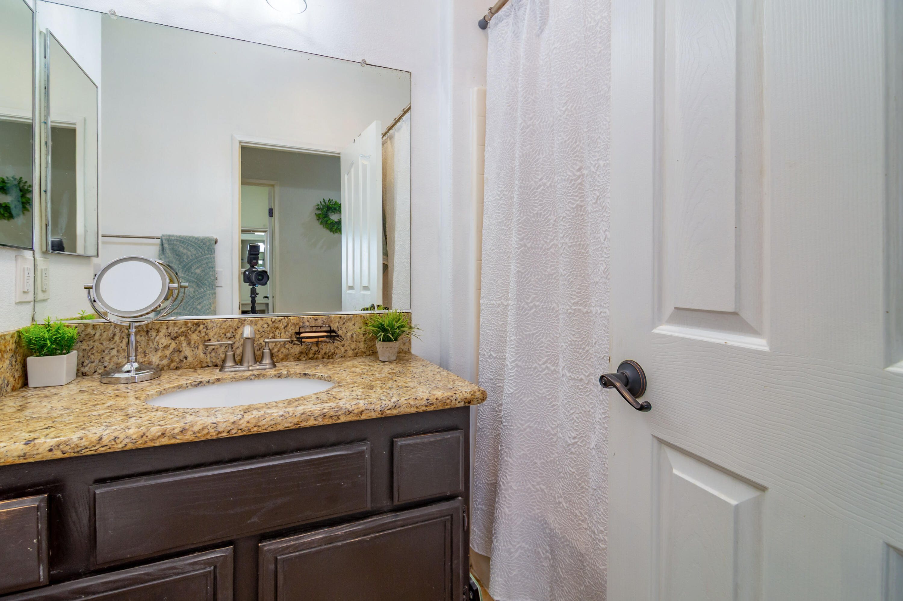 40681 Morris Street Indio, CA 92203 - Photo 23 of 36 a bathroom with a granite countertop sink and a mirror