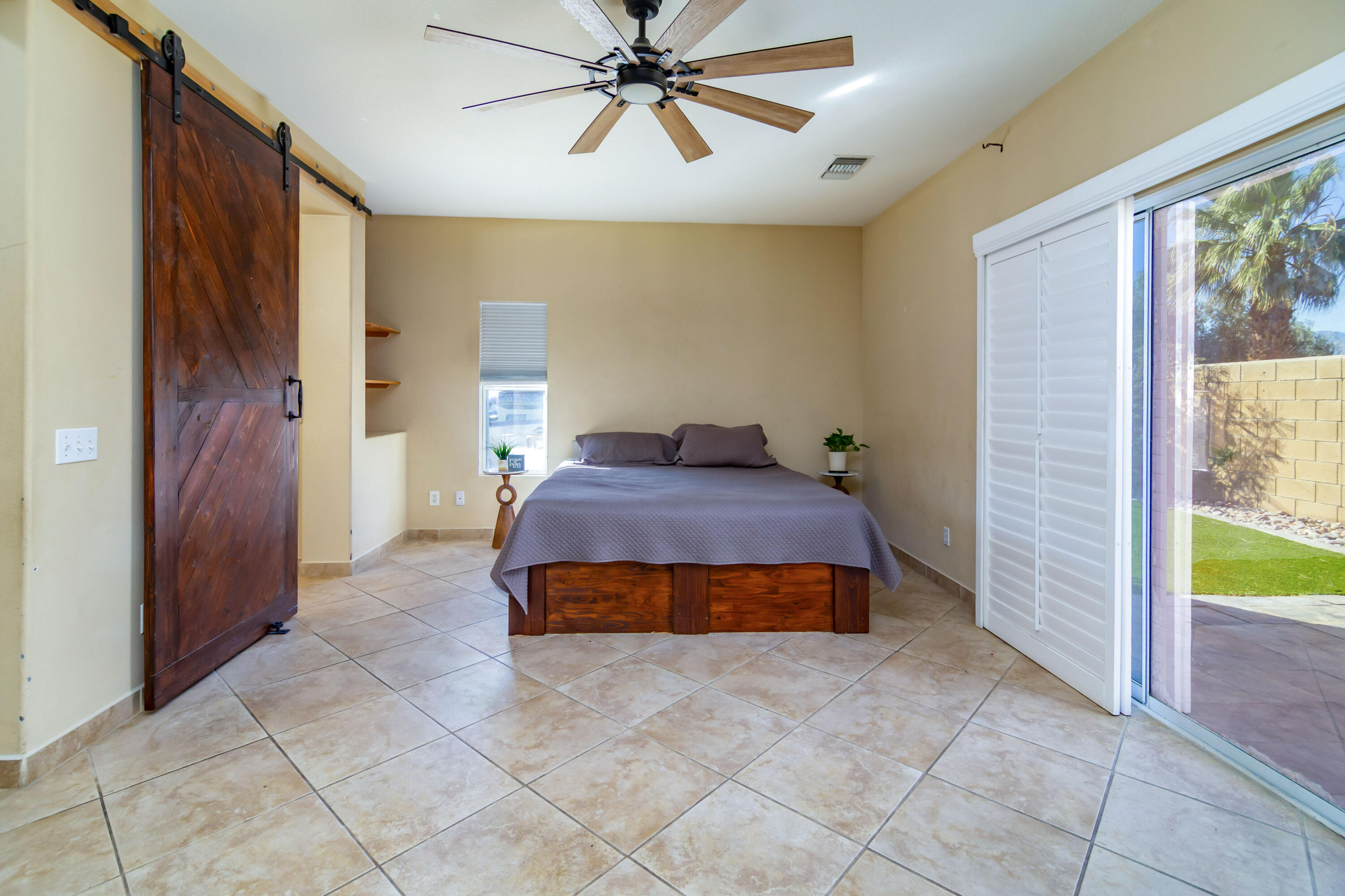 40681 Morris Street Indio, CA 92203 - Photo 31 of 36 a bedroom with a bed and a chandelier