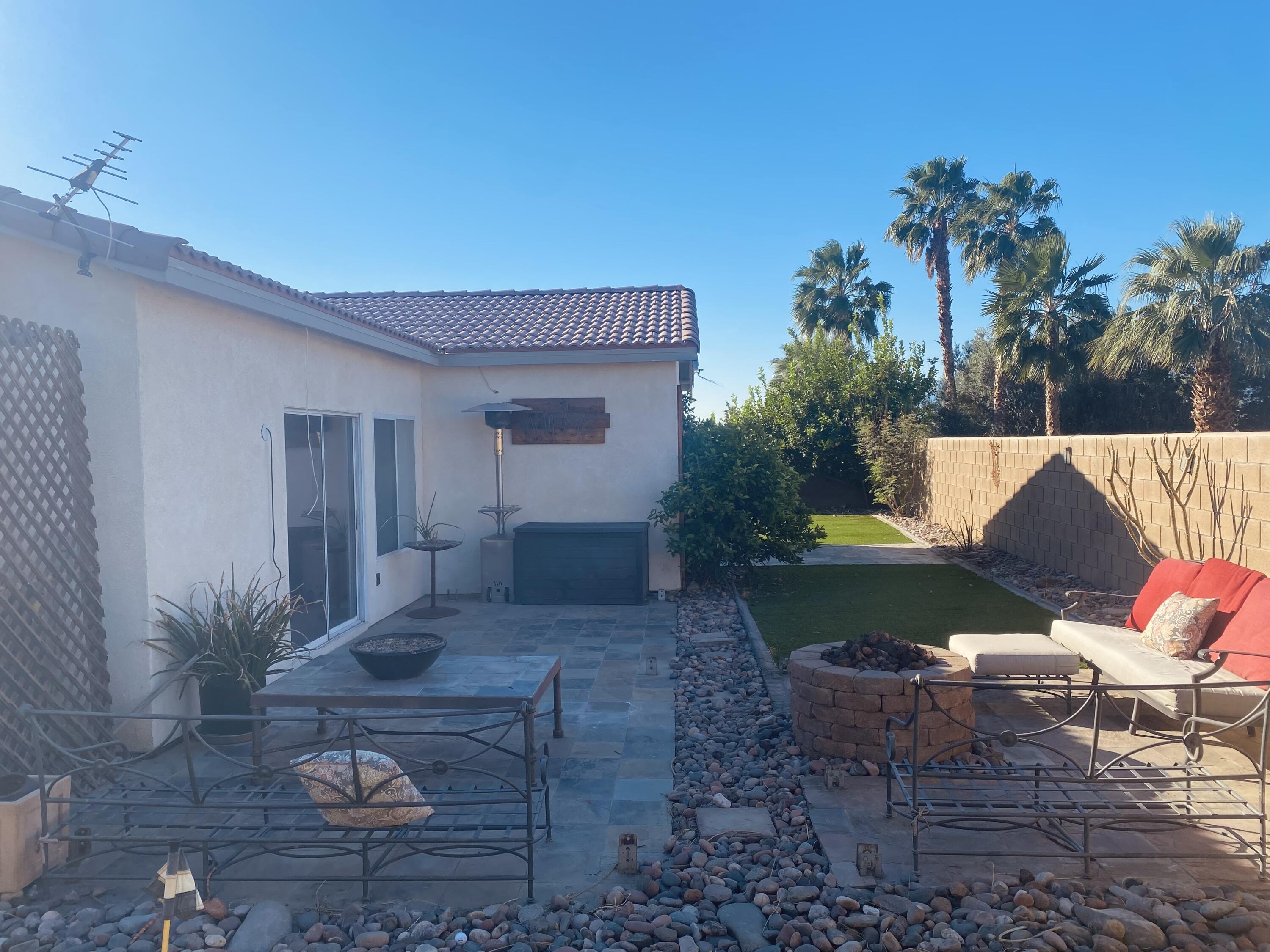 40681 Morris Street Indio, CA 92203 - Photo 36 of 36 a view of a patio with table and chairs potted plants with wooden floor