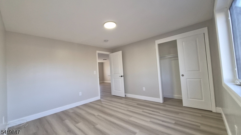 515 Maple Avenue, Unit 2 Rahway, NJ 07065 - Photo 12 of 13 a view of an empty room and wooden floor