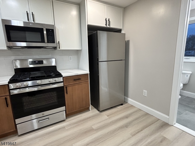 515 Maple Avenue, Unit 2 Rahway, NJ 07065 - Photo 3 of 13 a kitchen with a refrigerator stove and microwave