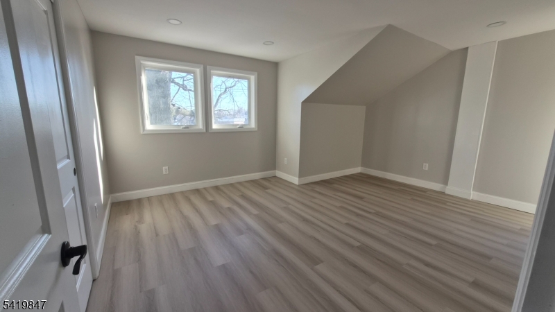 515 Maple Avenue, Unit 2 Rahway, NJ 07065 - Photo 7 of 13 a view of an empty room with wooden floor and a window