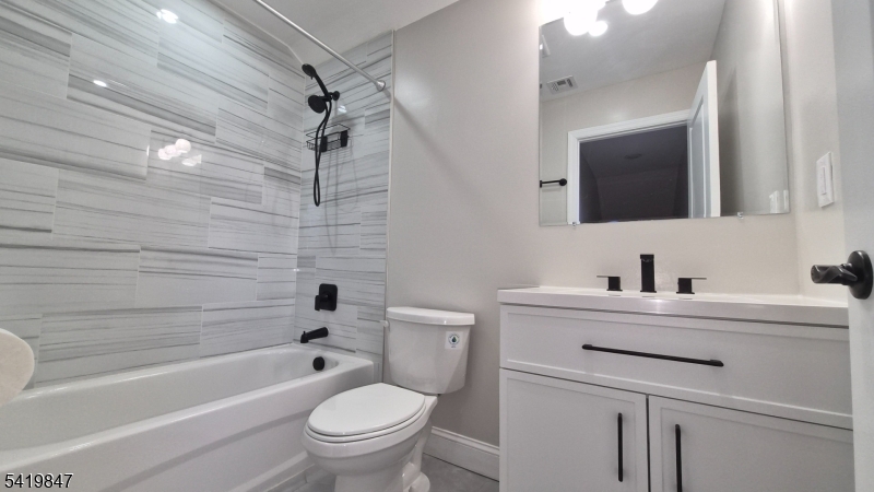 515 Maple Avenue, Unit 2 Rahway, NJ 07065 - Photo 9 of 13 a bathroom with a sink a toilet and shower
