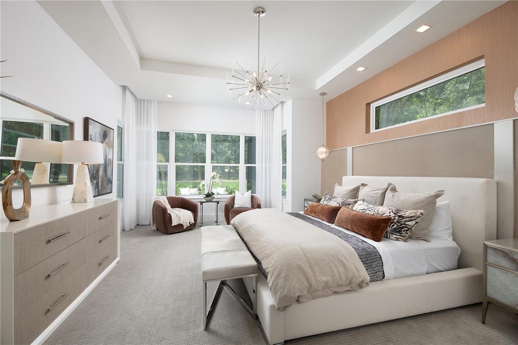 3120 Southwest 108 Way Gainesville, FL 32608 - Photo 13 of 29 a bedroom with double bed windows and a chandelier