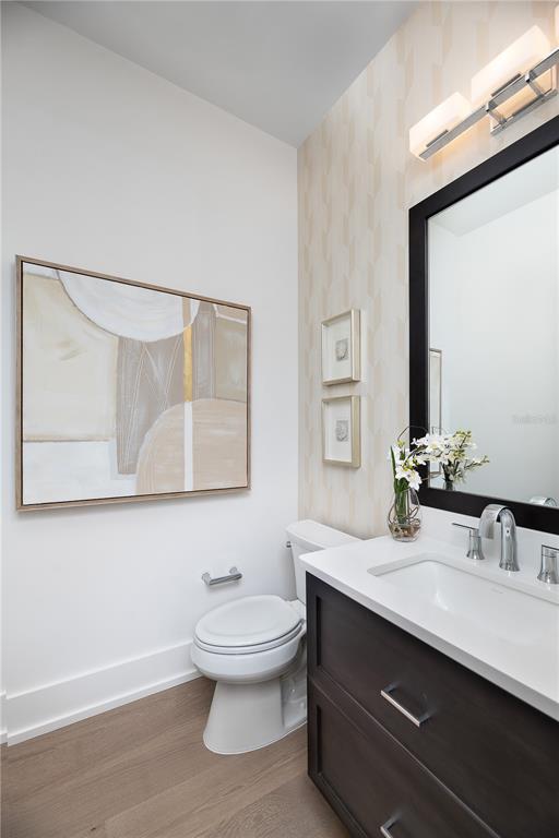3120 Southwest 108 Way Gainesville, FL 32608 - Photo 20 of 29 a bathroom with a toilet a sink and mirror