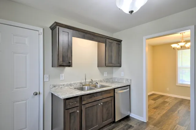 a kitchen with stainless steel appliances granite countertop a refrigerator stove and microwave