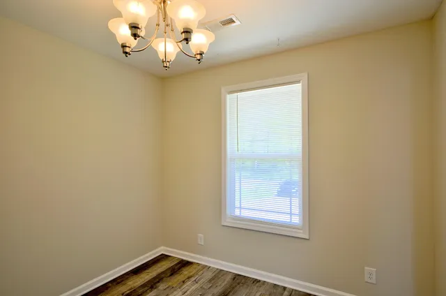 a view of a chandelier fan and refrigerator