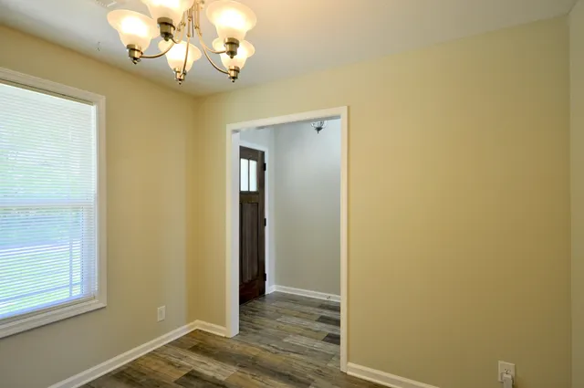 an empty room and chandelier fan