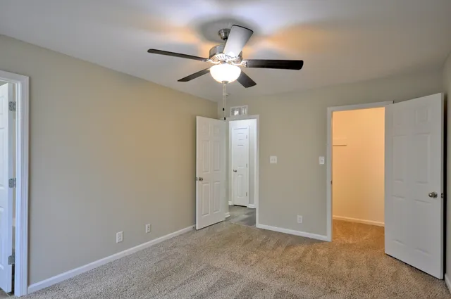a view of a chandelier fan and closet in a room