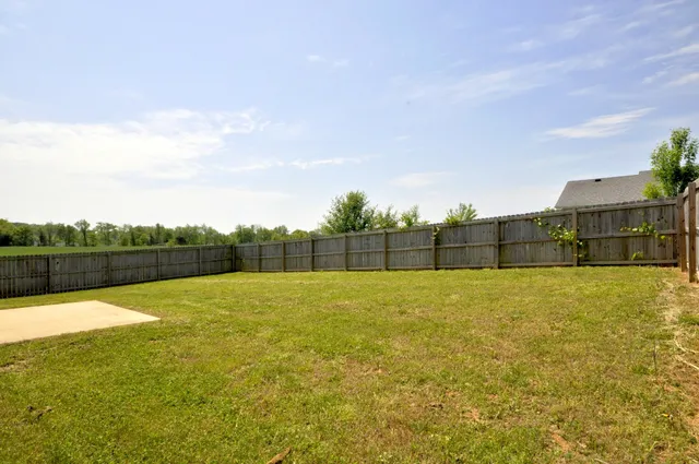 a front view of a house with a garden and yard