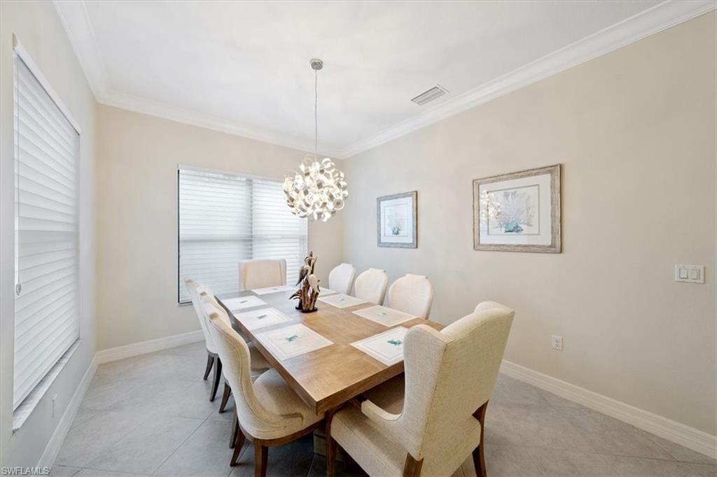13479 Sumter Lane Naples, FL 34109 - Photo 12 of 35 a view of a dining room with furniture and chandelier