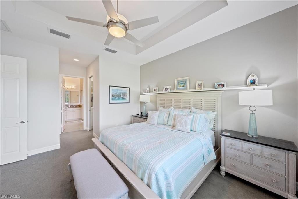 13479 Sumter Lane Naples, FL 34109 - Photo 14 of 35 a bedroom with a bed and a chandelier