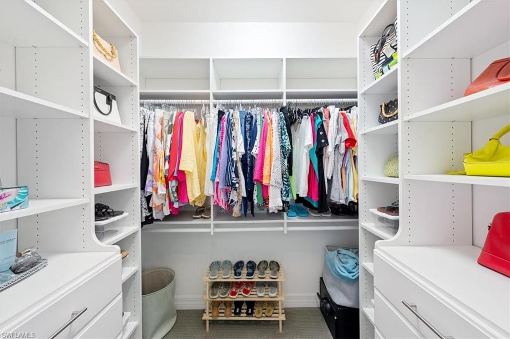 13479 Sumter Lane Naples, FL 34109 - Photo 16 of 35 a view of walk in closet with clothes and shoes