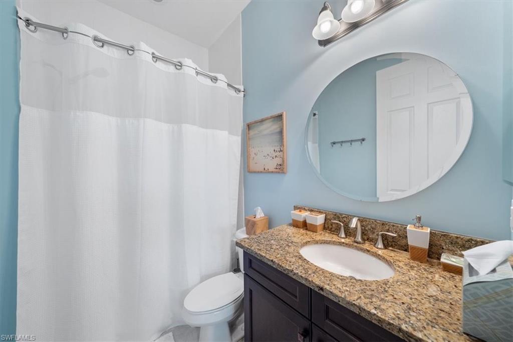 13479 Sumter Lane Naples, FL 34109 - Photo 22 of 35 a bathroom with a granite countertop sink and a mirror