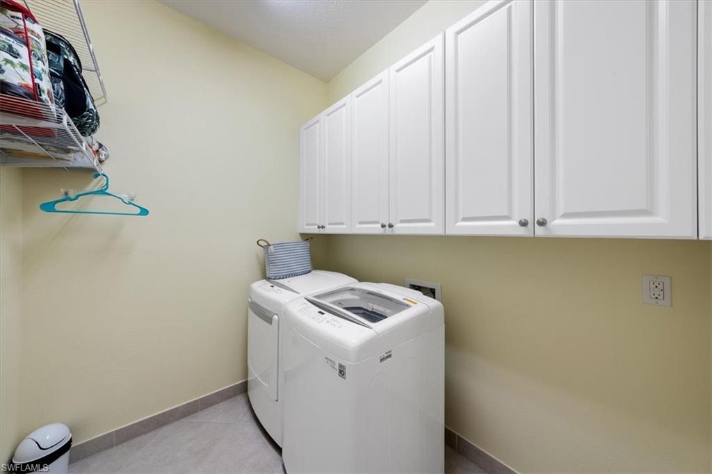 13479 Sumter Lane Naples, FL 34109 - Photo 23 of 35 a view of storage and utility room with washer and dryer
