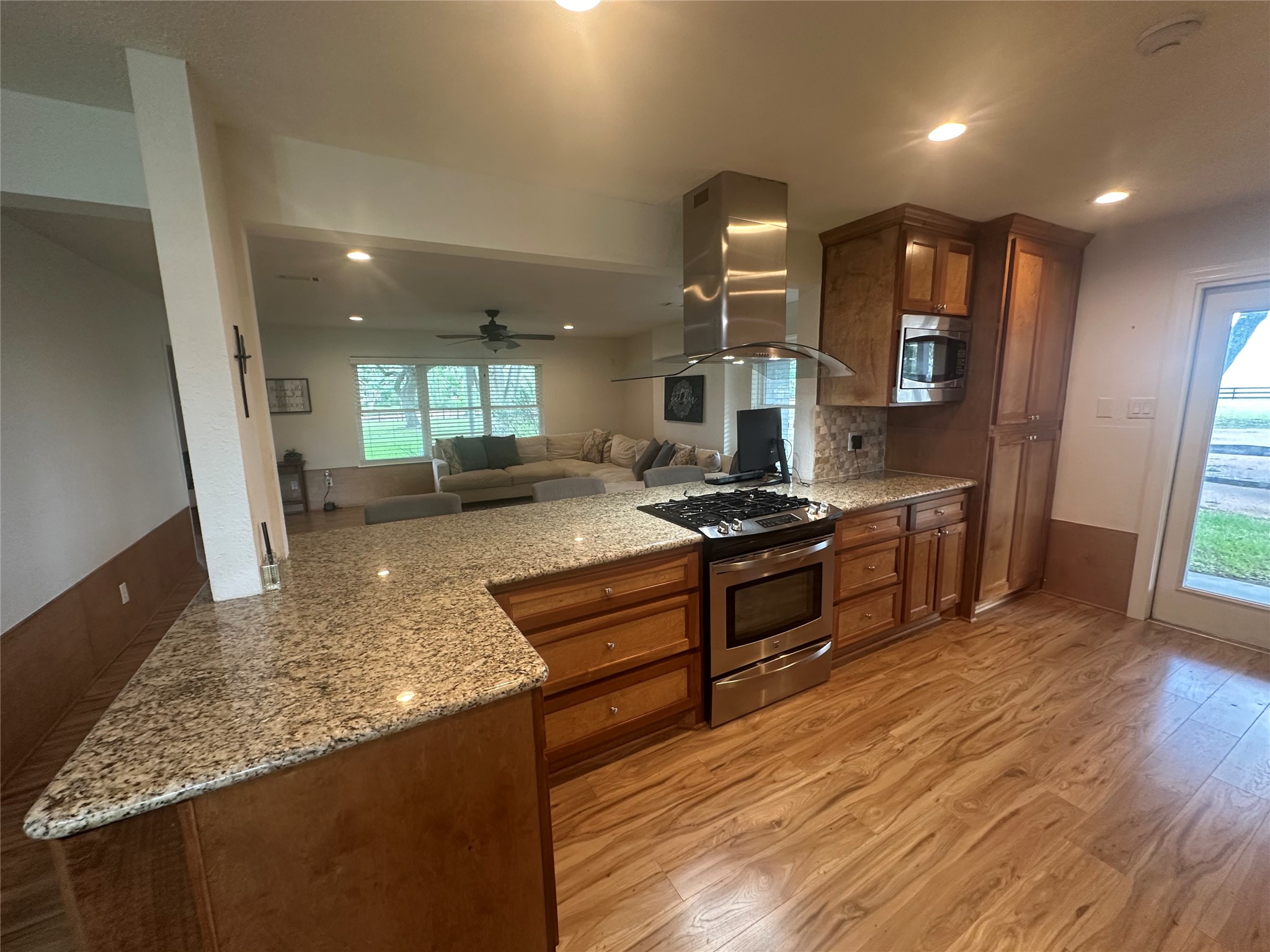 16607 Mueschke Road Cypress, TX 77433 - Photo 22 of 24 a kitchen with stainless steel appliances kitchen island granite countertop a stove a sink and a refrigerator