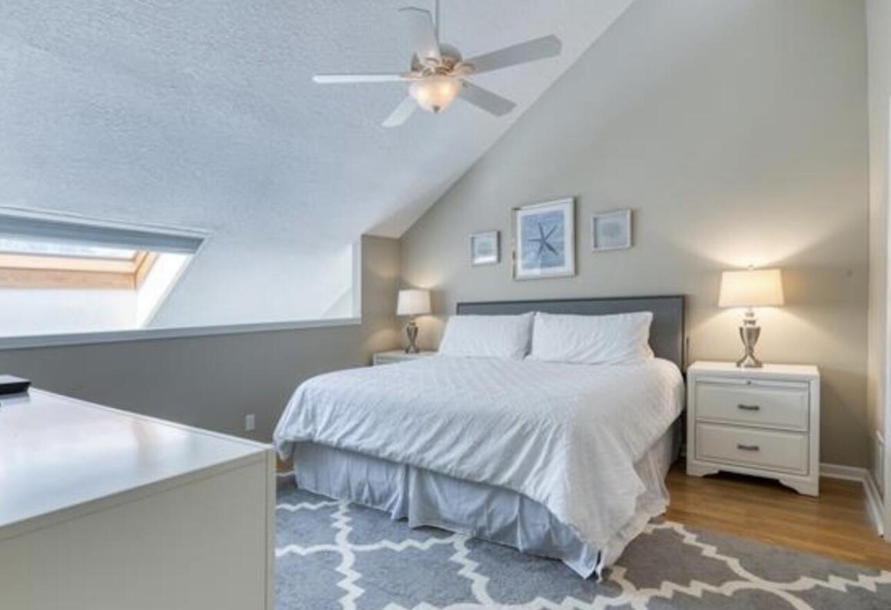 1605 Highway 1, Unit M2202 Jupiter, FL 33477 - Photo 12 of 19 a bedroom with a bed and a chandelier