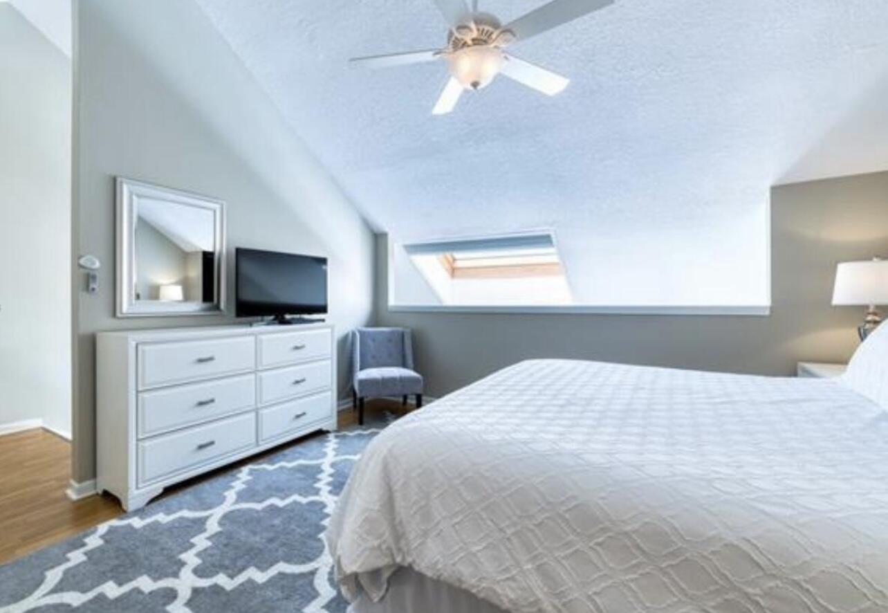 1605 Highway 1, Unit M2202 Jupiter, FL 33477 - Photo 13 of 19 a bedroom with a bed television on desk and a window