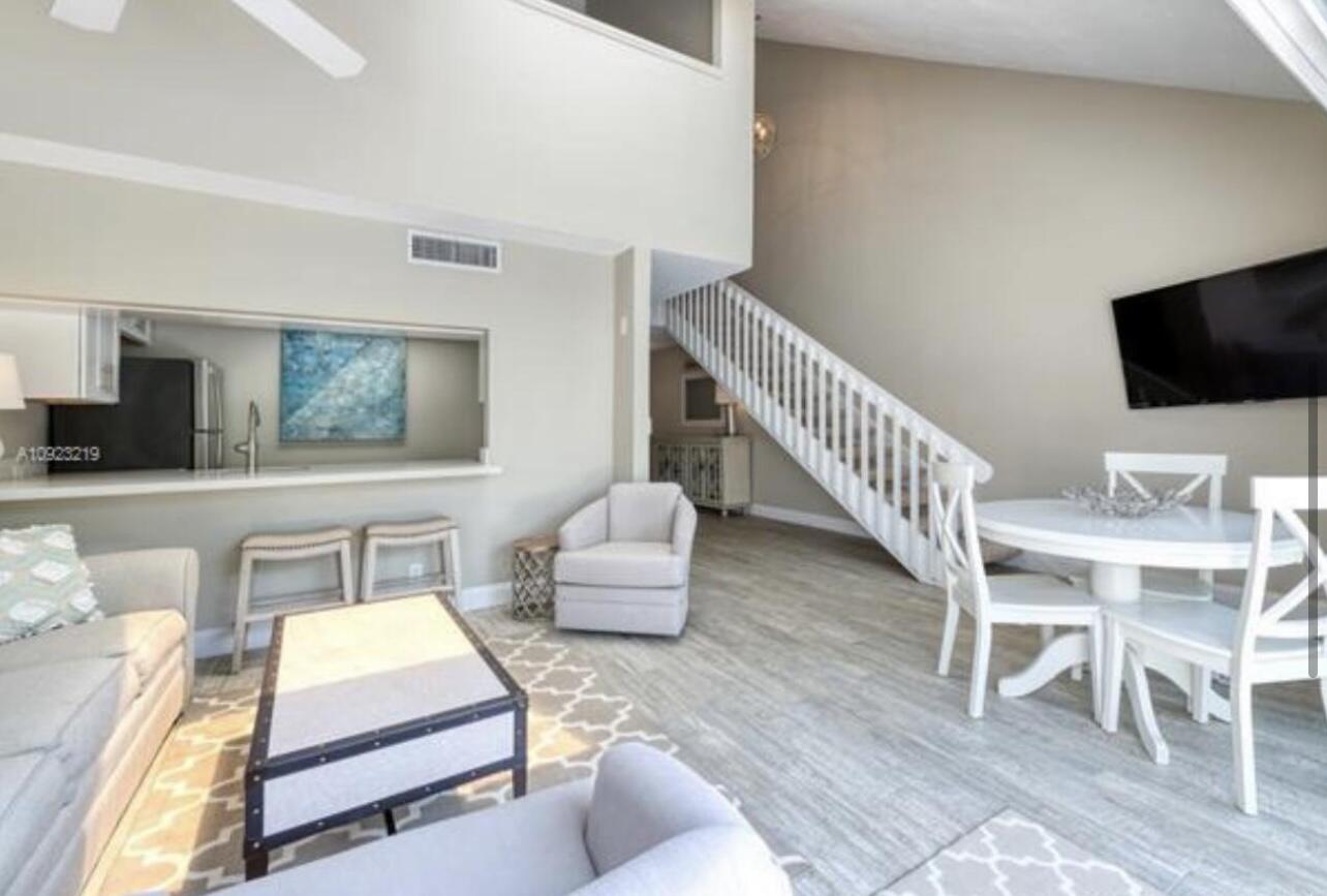 1605 Highway 1, Unit M2202 Jupiter, FL 33477 - Photo 4 of 19 a living room with furniture and a flat screen tv