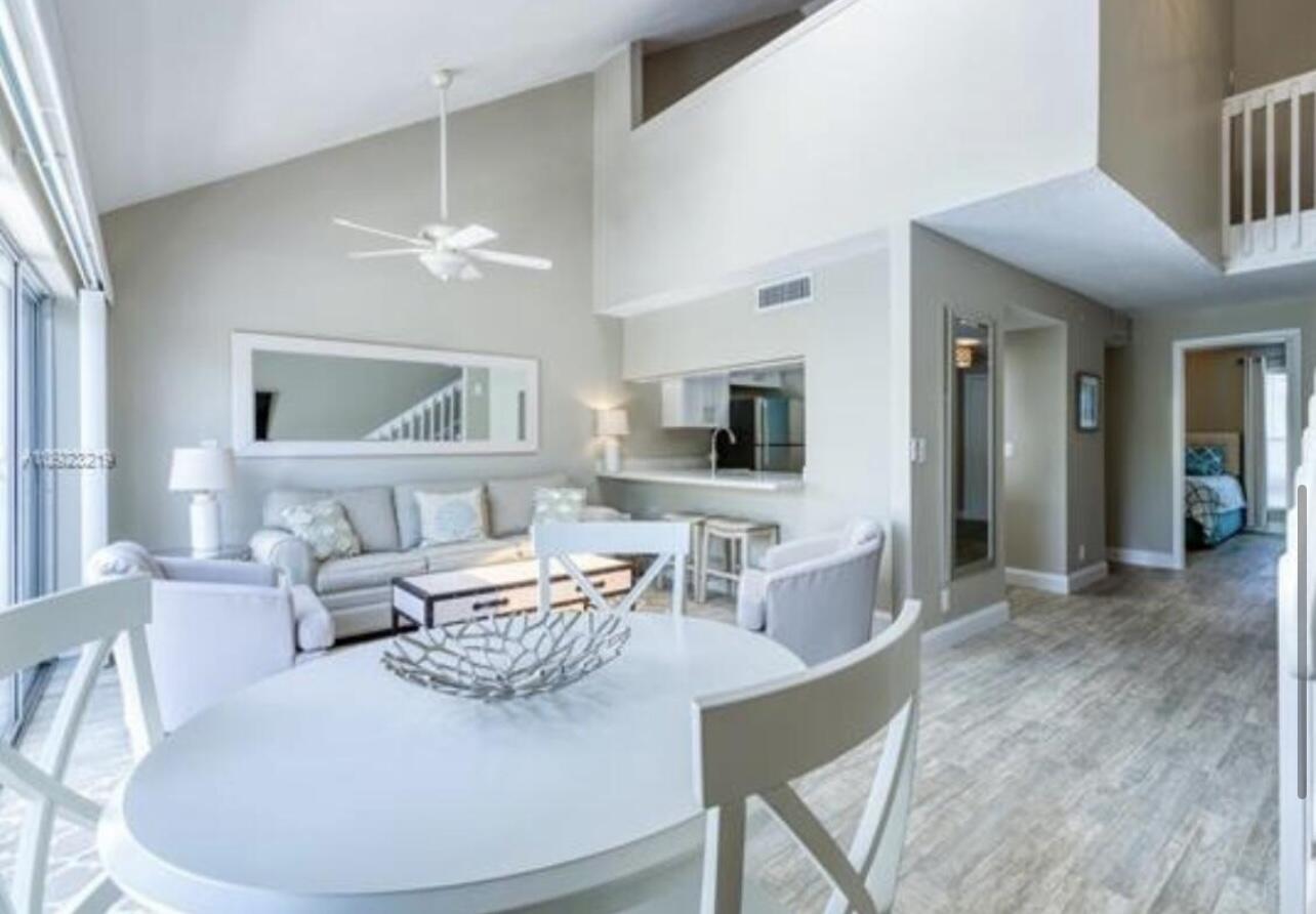 1605 Highway 1, Unit M2202 Jupiter, FL 33477 - Photo 5 of 19 a living room with furniture a flat screen tv and kitchen view