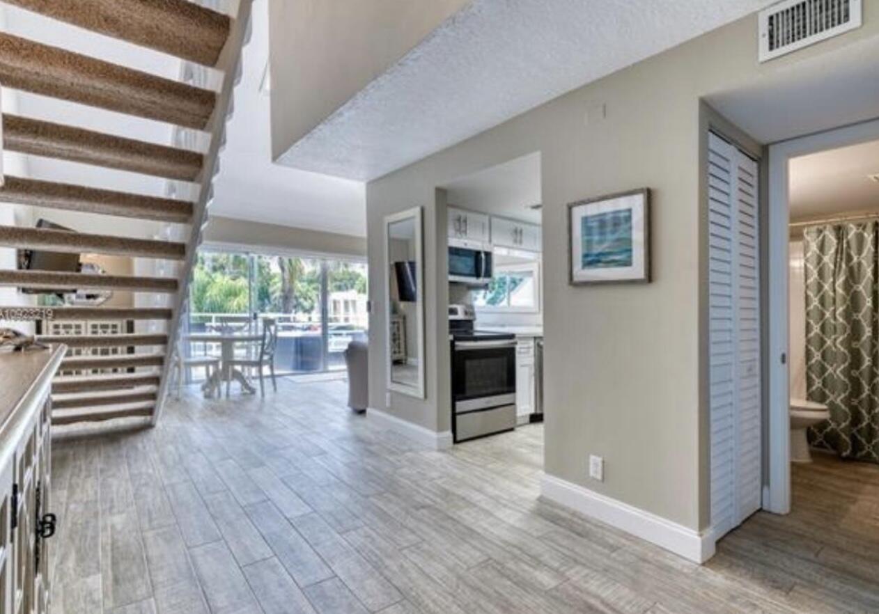 1605 Highway 1, Unit M2202 Jupiter, FL 33477 - Photo 6 of 19 a view of kitchen with furniture and wooden floor