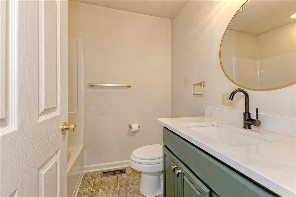 147 South Quarry Street Mount Pleasant, PA 15666 - Photo 15 of 30 a bathroom with a sink a toilet and a mirror