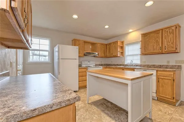 a kitchen with a refrigerator a stove a sink and a counter top space