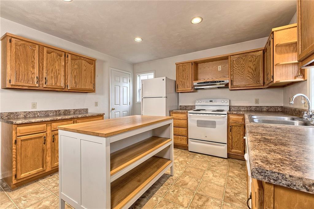 147 South Quarry Street Mount Pleasant, PA 15666 - Photo 19 of 30 a kitchen with white cabinets and appliances
