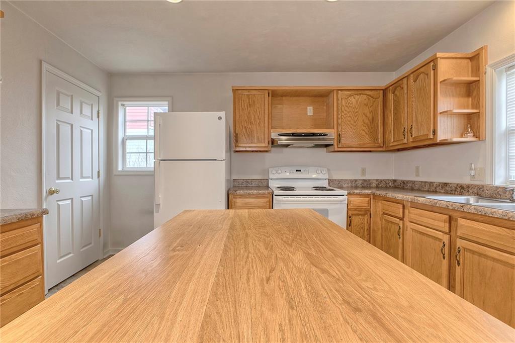 147 South Quarry Street Mount Pleasant, PA 15666 - Photo 24 of 30 a kitchen with a refrigerator sink and cabinets